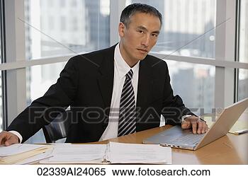 Stock Image - businessman at 
table with laptop. 
fotosearch - search 
stock photos, 
pictures, images, 
and photo clipart