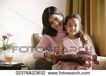 Stock Photo - little girl sits 
on mother's lap, 
both smile at 
camera. fotosearch 
- search stock 
photos, pictures, 
images, and photo 
clipart