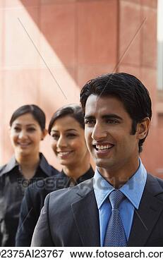 Picture - one businessman 
in foreground, 
 two businesswomen 
in background, 
 all. fotosearch 
- search stock 
photos, pictures, 
images, and photo 
clipart