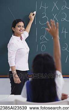 Stock Photograph - teacher at chalkboard, 
girl raises hand. 
fotosearch - search 
stock photos, 
pictures, images, 
and photo clipart