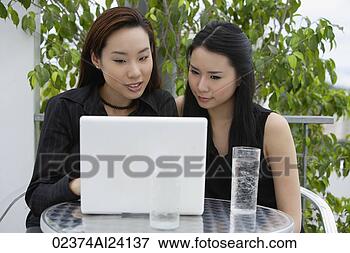 Picture - two ladies at 
lap top computer. 
fotosearch - search 
stock photos, 
pictures, images, 
and photo clipart
