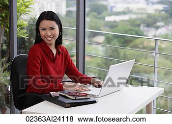 Stock Photo - woman working 
at desk. fotosearch 
- search stock 
photos, pictures, 
images, and photo 
clipart