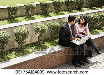 Stock Photograph - business associates 
working outside, 
laptop computer. 
fotosearch - search 
stock photos, 
pictures, images, 
and photo clipart