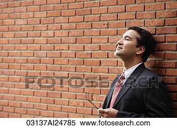 Stock Image - businessman leaning 
against wall. 
fotosearch - search 
stock photos, 
pictures, images, 
and photo clipart