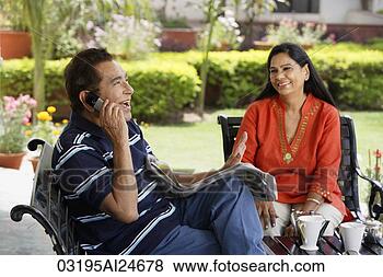 Stock Photo - couple sitting 
on patio, man 
on phone. fotosearch 
- search stock 
photos, pictures, 
images, and photo 
clipart