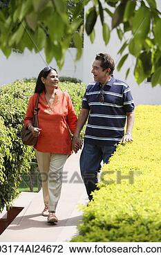 Stock Photo - couple walking 
on path holding 
hands. fotosearch 
- search stock 
photos, pictures, 
images, and photo 
clipart