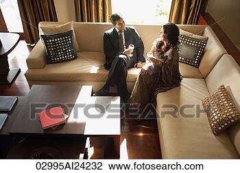 Stock Photo - man and woman 
sitting on couch. 
fotosearch - search 
stock photos, 
pictures, images, 
and photo clipart