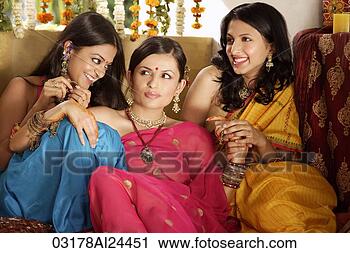 Stock Photography - three young women 
wearing saris, 
one with bindi. 
fotosearch - search 
stock photos, 
pictures, images, 
and photo clipart