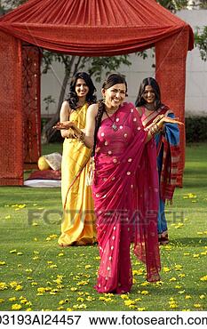 Picture - three young women 
wearing saris, 
in front of tent. 
fotosearch - search 
stock photos, 
pictures, images, 
and photo clipart