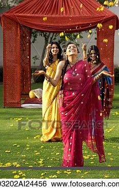 Stock Photo - two young women 
throwing petals 
on another woman, 
 all three wearing. 
fotosearch - search 
stock photos, 
pictures, images, 
and photo clipart