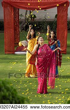 Stock Image - two young women 
throwing petals 
on another woman, 
 all three wearing. 
fotosearch - search 
stock photos, 
pictures, images, 
and photo clipart