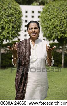 Stock Photo - woman outdoors, 
wearing salwar 
kameez and shawl. 
fotosearch - search 
stock photos, 
pictures, images, 
and photo clipart