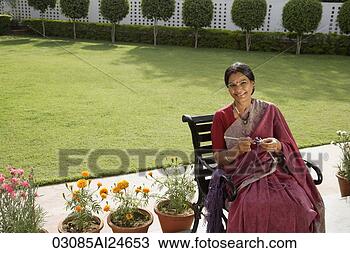 Stock Photo - woman wearing 
a sari, knitting. 
fotosearch - search 
stock photos, 
pictures, images, 
and photo clipart