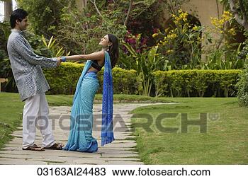 Stock Photo - young couple dancing 
in garden. fotosearch 
- search stock 
photos, pictures, 
images, and photo 
clipart