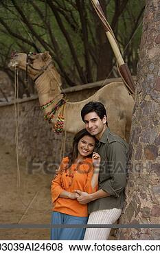 Stock Photo - young couple embracing, 
camel at background. 
fotosearch - search 
stock photos, 
pictures, images, 
and photo clipart