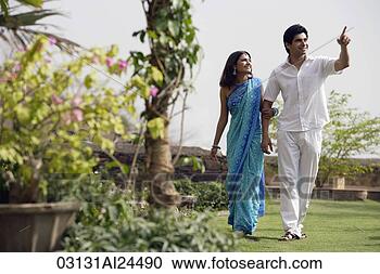 Stock Photography - young couple strolling 
in garden. fotosearch 
- search stock 
photos, pictures, 
images, and photo 
clipart