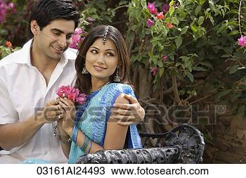 Stock Photo - young woman accepting 
flowers from young 
man. fotosearch 
- search stock 
photos, pictures, 
images, and photo 
clipart