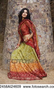 Stock Photograph - young woman in 
sari, stone pillar. 
fotosearch - search 
stock photos, 
pictures, images, 
and photo clipart