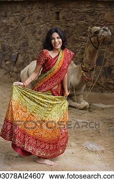 Picture - young woman in 
sari, in front 
of camel. fotosearch 
- search stock 
photos, pictures, 
images, and photo 
clipart