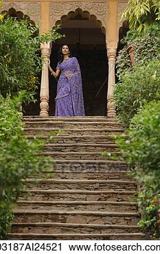 Stock Photography - young woman in 
sari, standing 
at top of stairs. 
fotosearch - search 
stock photos, 
pictures, images, 
and photo clipart
