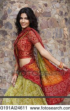 Stock Photography - young woman in 
sari, stone wall. 
fotosearch - search 
stock photos, 
pictures, images, 
and photo clipart