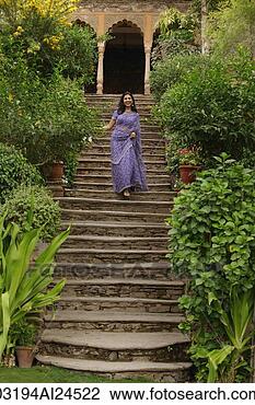 Stock Photo - young woman in 
sari walking down 
the stairs. fotosearch 
- search stock 
photos, pictures, 
images, and photo 
clipart