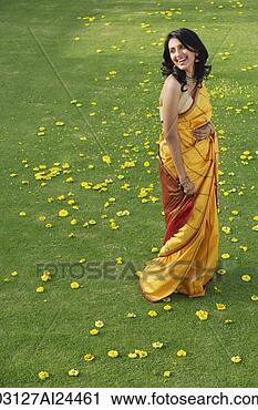Stock Photography - young woman in 
yellow sari. fotosearch 
- search stock 
photos, pictures, 
images, and photo 
clipart