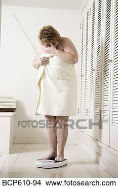 Stock Photo - ashamed overweight 
woman on bathroom 
scale. fotosearch 
- search stock 
photos, pictures, 
images, and photo 
clipart