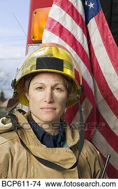 Stock Photo - female firefighter 
with american 
flag. fotosearch 
- search stock 
photos, pictures, 
images, and photo 
clipart