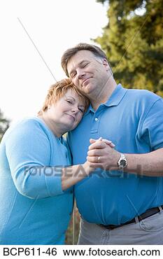 Stock Photo - happy middle aged 
couple dancing 
outside. fotosearch 
- search stock 
photos, pictures, 
images, and photo 
clipart