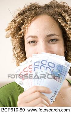 Stock Photography - happy woman hiding 
behind euros. 
fotosearch - search 
stock photos, 
pictures, images, 
and photo clipart
