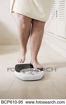 Stock Image - legs of overweight 
woman stepping 
onto scale. fotosearch 
- search stock 
photos, pictures, 
images, and photo 
clipart