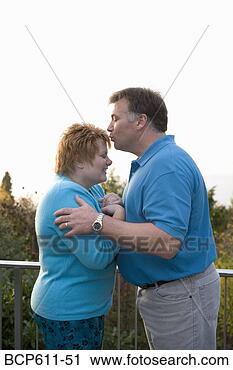 Stock Photography - man kissing wife 
on balcony. fotosearch 
- search stock 
photos, pictures, 
images, and photo 
clipart