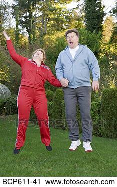 Stock Photography - middle aged couple 
jumping outdoors. 
fotosearch - search 
stock photos, 
pictures, images, 
and photo clipart