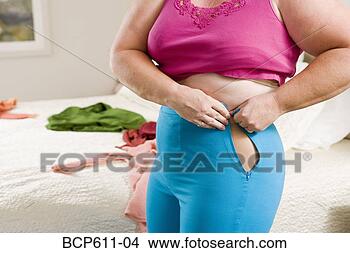 Stock Photo - overweight woman 
squeezing into 
small pants. fotosearch 
- search stock 
photos, pictures, 
images, and photo 
clipart