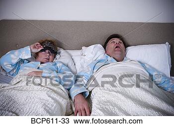 Stock Photo - woman awakened 
by snoring husband. 
fotosearch - search 
stock photos, 
pictures, images, 
and photo clipart