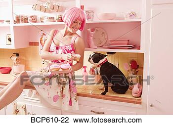 Stock Photo - woman in retro 
kitchen with dog 
and cupcakes. 
fotosearch - search 
stock photos, 
pictures, images, 
and photo clipart