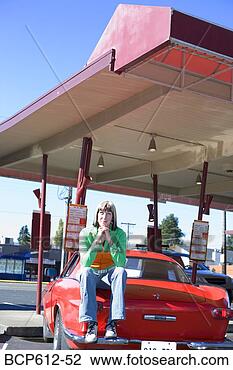 Stock Photo - woman sitting 
on sports car 
at drive-in. fotosearch 
- search stock 
photos, pictures, 
images, and photo 
clipart