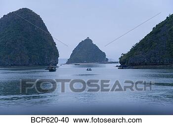 Stock Photography - boats and islands 
at dusk on vietnamese 
bay. fotosearch 
- search stock 
photos, pictures, 
images, and photo 
clipart