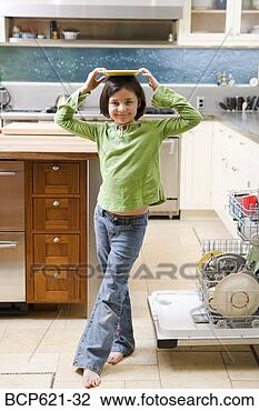 Stock Photo - girl balancing 
plate on head 
in kitchen. fotosearch 
- search stock 
photos, pictures, 
images, and photo 
clipart