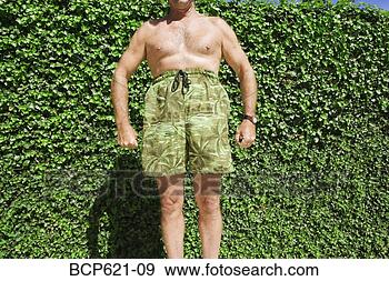 Stock Photograph - man posing comically 
in swimming trunks. 
fotosearch - search 
stock photos, 
pictures, images, 
and photo clipart
