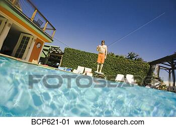 Stock Photography - outdoor pool with 
man on diving 
board. fotosearch 
- search stock 
photos, pictures, 
images, and photo 
clipart