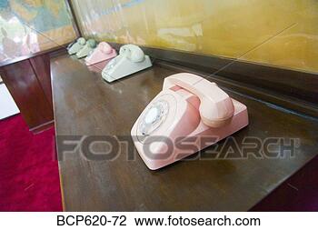 Stock Photo - pastel colored 
telephones on 
counter with maps. 
fotosearch - search 
stock photos, 
pictures, images, 
and photo clipart