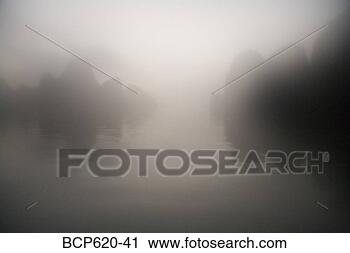 Stock Photography - rocks and water 
through mist at 
dawn. fotosearch 
- search stock 
photos, pictures, 
images, and photo 
clipart