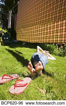 Stock Photo - woman lying in 
grass under drying 
laundry. fotosearch 
- search stock 
photos, pictures, 
images, and photo 
clipart
