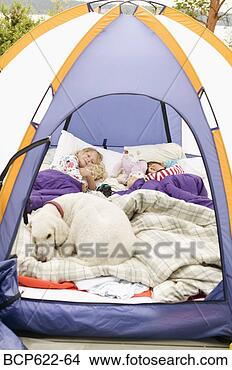 Stock Photo - young girls sleeping 
in tent with dog. 
fotosearch - search 
stock photos, 
pictures, images, 
and photo clipart