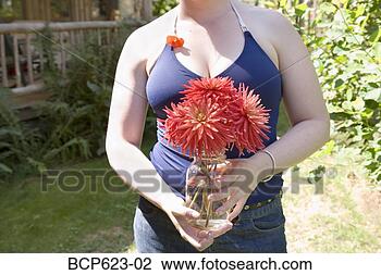 Stock Photo - young woman holding 
jar of cut flowers. 
fotosearch - search 
stock photos, 
pictures, images, 
and photo clipart