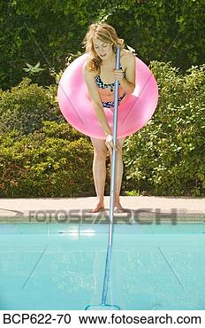 Stock Photography - young woman poolside 
with pink floatation 
device. fotosearch 
- search stock 
photos, pictures, 
images, and photo 
clipart