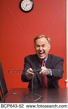 Stock Photo - businessman playing 
video games. fotosearch 
- search stock 
photos, pictures, 
images, and photo 
clipart