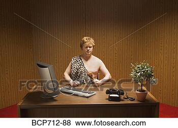 Stock Photo - businessman dressed 
as caveman at 
desk. fotosearch 
- search stock 
photos, pictures, 
images, and photo 
clipart